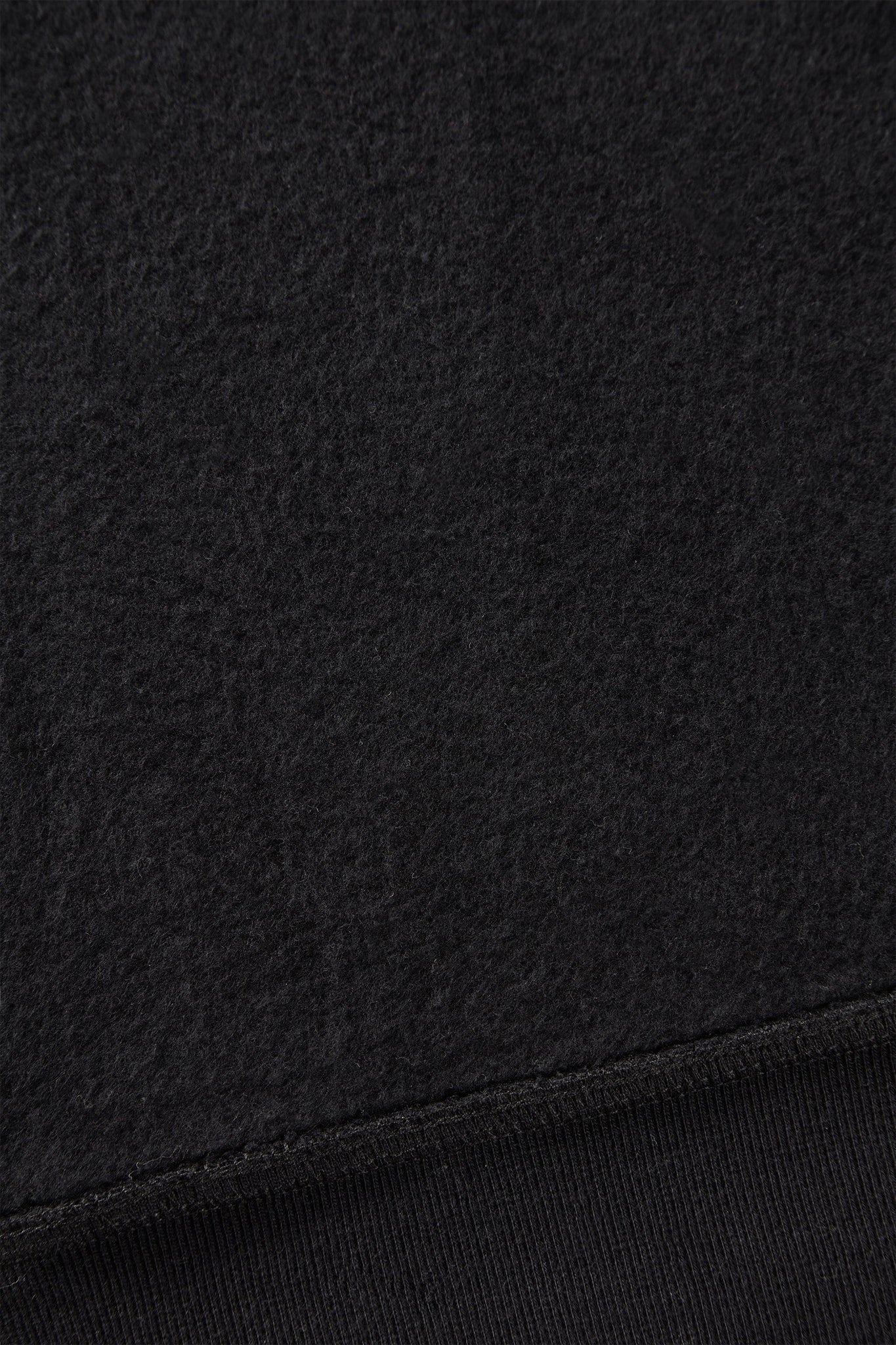 alt="detail of black hooded sweatshirt cotton brushed on the inside"