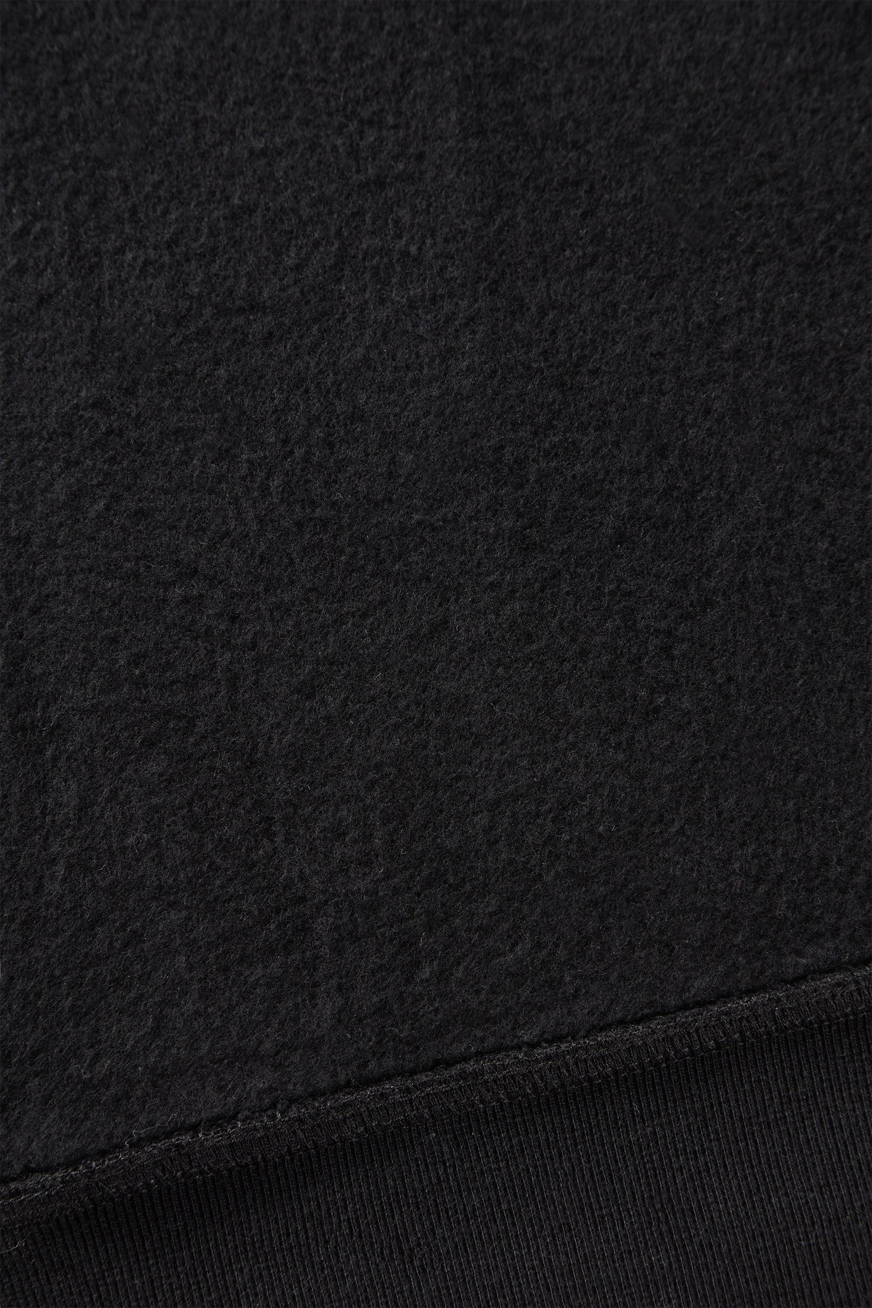 alt="detail of black hooded sweatshirt cotton brushed on the inside"