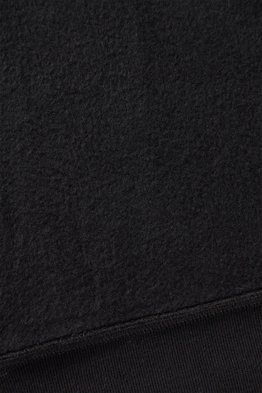 alt="detail of black hooded sweatshirt cotton brushed on the inside"