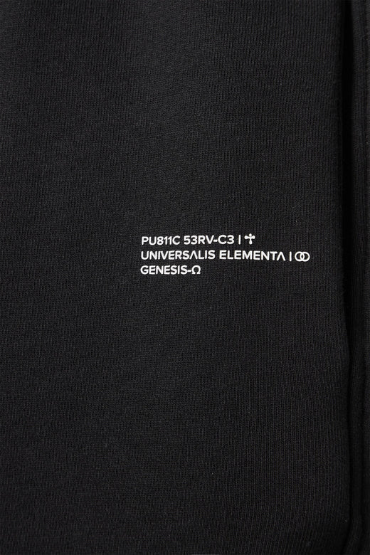 alt="detail text print of black track pants"